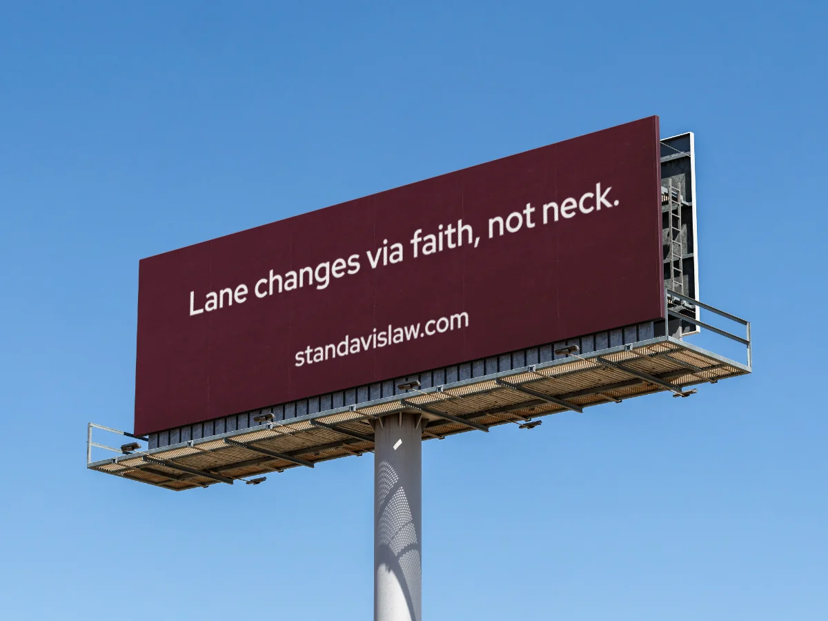 Billboard reading "Lane changes via faith, not neck."